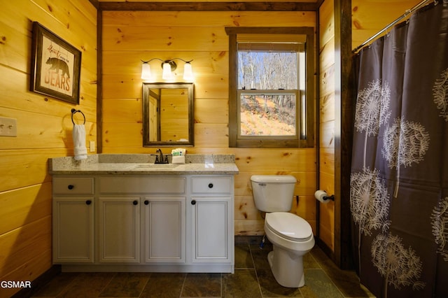 full bath featuring a shower with shower curtain, toilet, wooden walls, and vanity