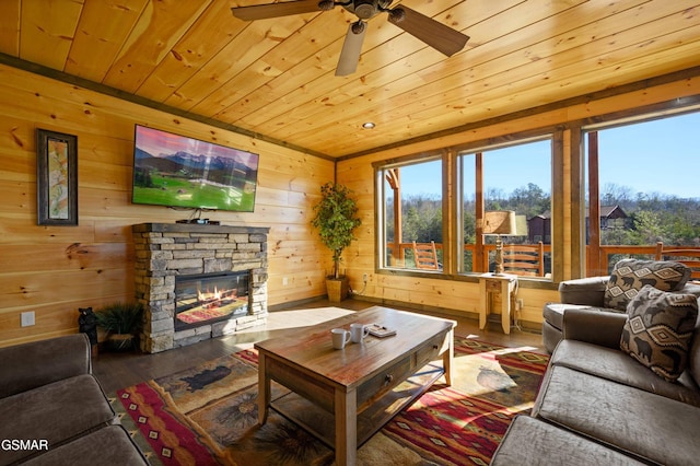 living room with a wealth of natural light, wooden ceiling, and wood finished floors