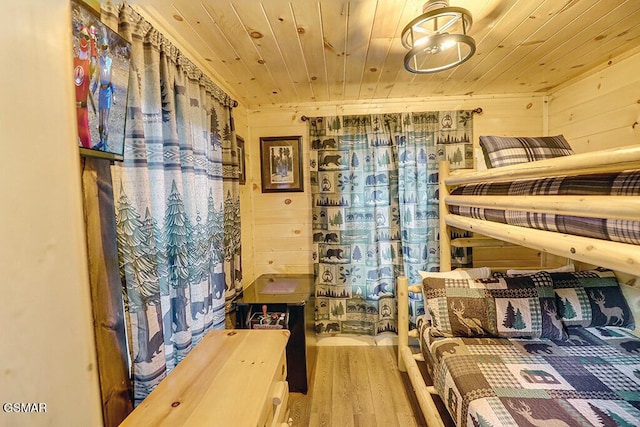 bedroom with hardwood / wood-style flooring, wood walls, and wooden ceiling