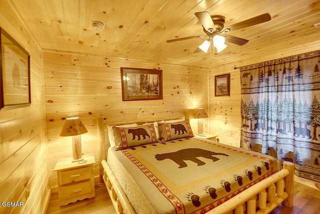 bedroom featuring wood ceiling, ceiling fan, wood-type flooring, and wood walls