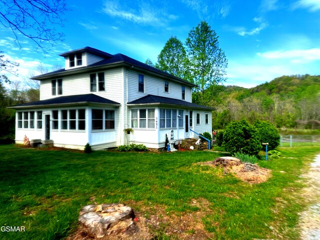 3451 Cosby Hwy, Cosby, TN 37722 - rear view of property featuring a yard, a sunroom, fence, and roof with shingles
