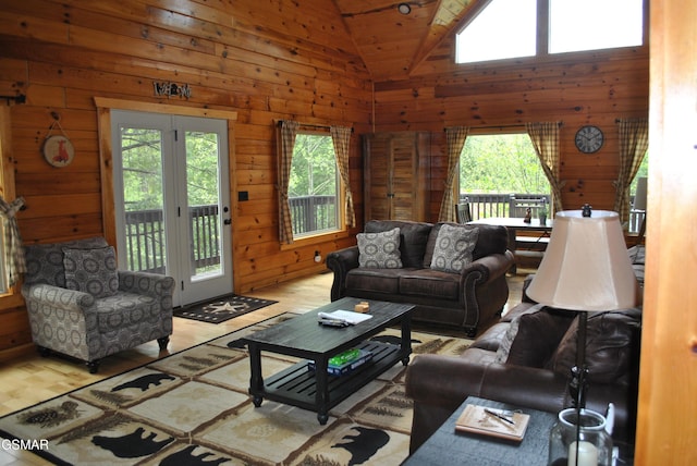 living room featuring wood finished floors, wood walls, and a wealth of natural light
