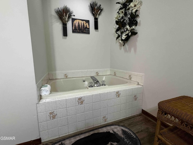 full bath featuring a garden tub and wood finished floors