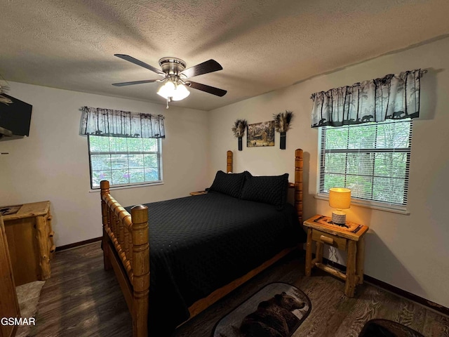 bedroom with baseboards, a textured ceiling, ceiling fan, and wood finished floors