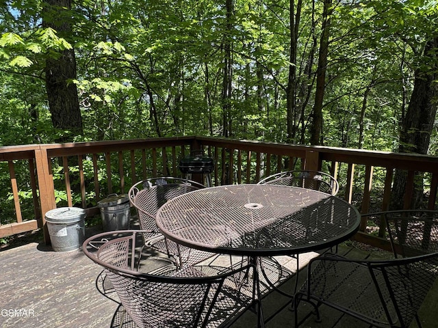 wooden terrace featuring outdoor dining area