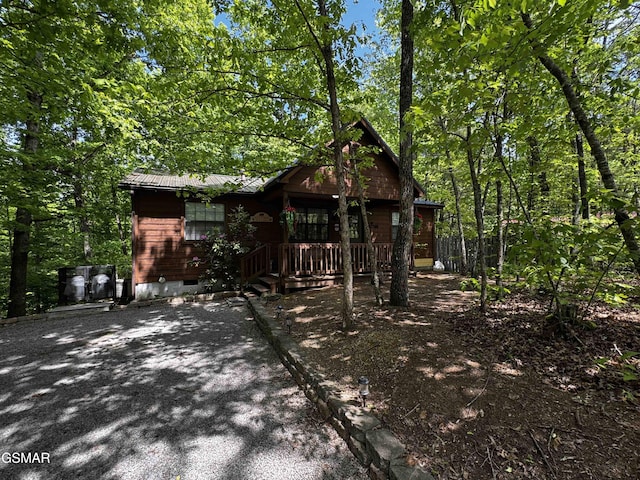 view of front of home featuring covered porch, crawl space, and metal roof