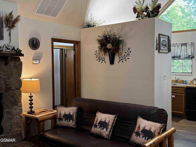 living room with wood finished floors and visible vents