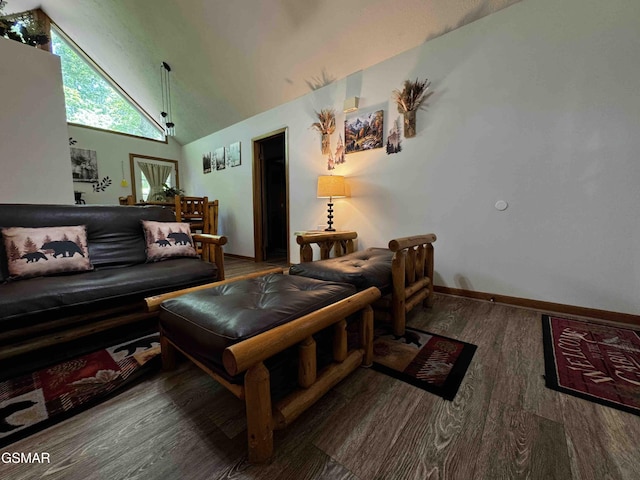 living room with baseboards, high vaulted ceiling, and wood finished floors