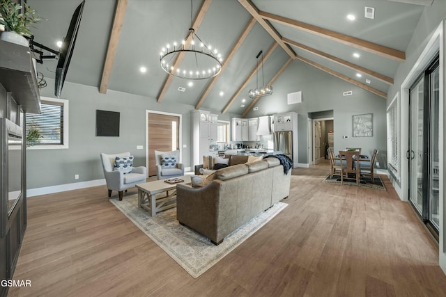 living room featuring high vaulted ceiling, beam ceiling, light wood finished floors, and an inviting chandelier