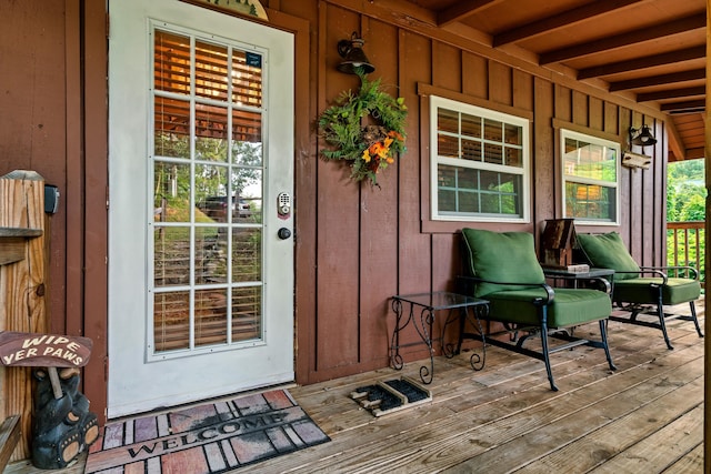 entrance to property featuring a porch and board and batten siding