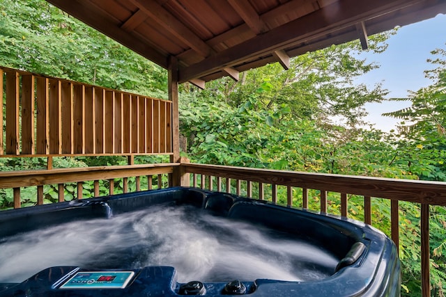 wooden deck featuring a hot tub