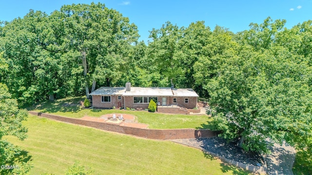 944 Smoky Mountain View Ct, Seymour, TN 37865 - ranch-style house featuring a chimney, a front lawn, a view of trees, and brick siding