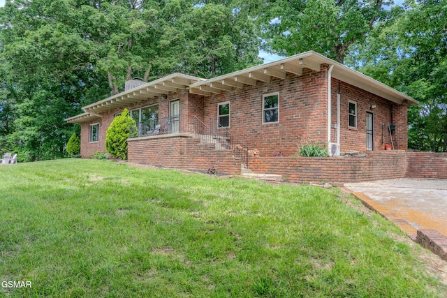 944 Smoky Mountain View Ct, Seymour, TN 37865 - view of front facade featuring a chimney, a front yard, and brick siding
