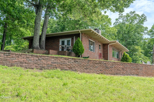 944 Smoky Mountain View Ct, Seymour, TN 37865 - ranch-style home with a chimney, brick siding, and a front yard
