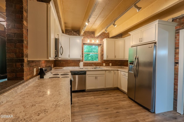 944 Smoky Mountain View Ct, Seymour, TN 37865 - kitchen featuring stainless steel appliances, brick wall, track lighting, a sink, and beamed ceiling