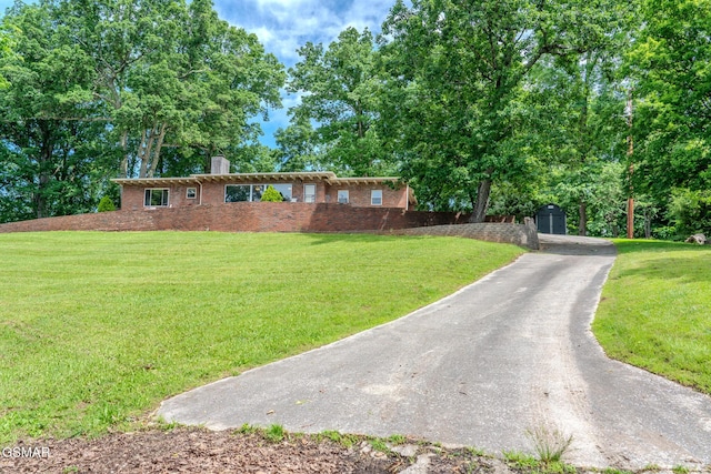 944 Smoky Mountain View Ct, Seymour, TN 37865 - view of front of home featuring a chimney, brick siding, and a front lawn