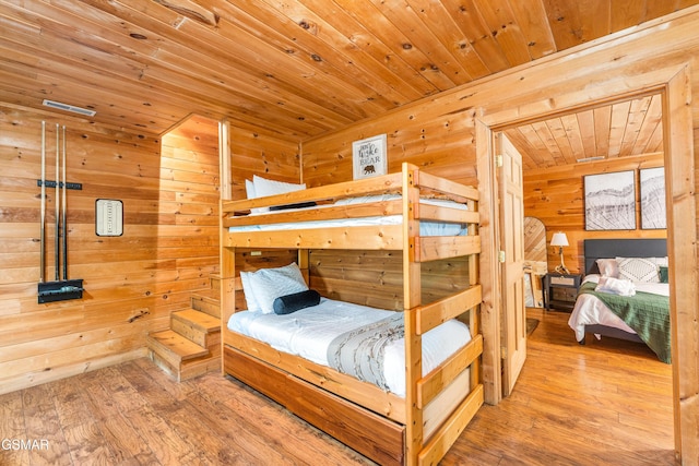 3186 Emerald Springs Loop, Pigeon Forge, TN 37862 - bedroom featuring wood ceiling, wood walls, and hardwood / wood-style flooring