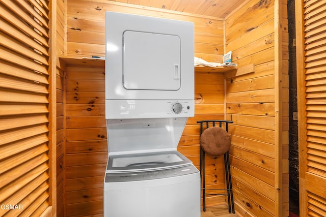 3186 Emerald Springs Loop, Pigeon Forge, TN 37862 - washroom featuring stacked washing machine and dryer and wooden walls