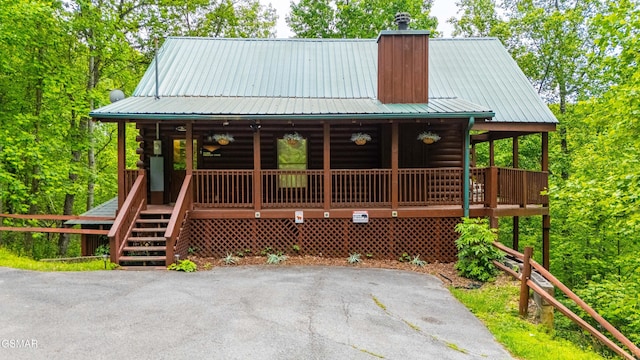 3186 Emerald Springs Loop, Pigeon Forge, TN 37862 - cabin featuring a chimney, a porch, log siding, and metal roof
