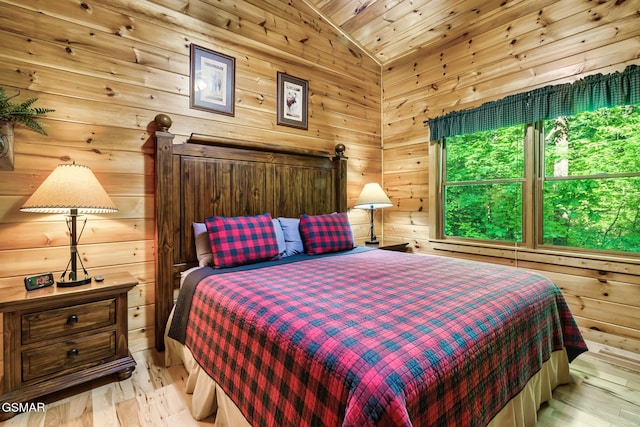 3828 Saddle Brook Way, Sevierville, TN 37862 - bedroom with vaulted ceiling, light wood-style flooring, and wooden walls