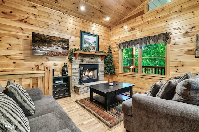3828 Saddle Brook Way, Sevierville, TN 37862 - living room featuring vaulted ceiling, recessed lighting, wooden walls, wood finished floors, and a fireplace