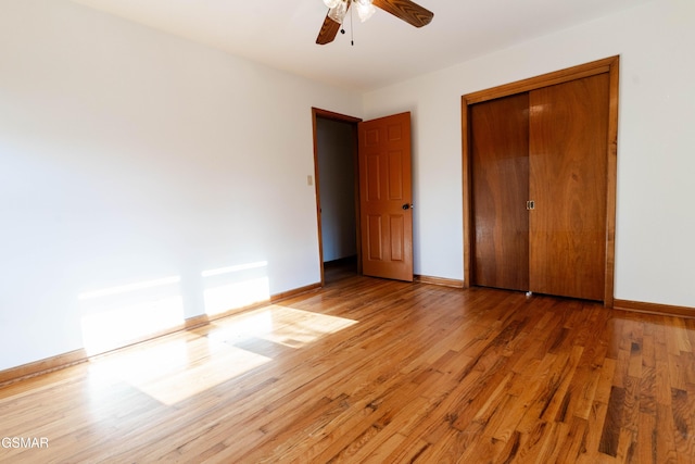 unfurnished bedroom with light wood-style floors, a ceiling fan, baseboards, and a closet