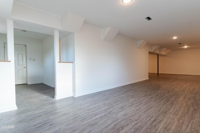 interior space with crown molding, recessed lighting, baseboards, and wood finished floors
