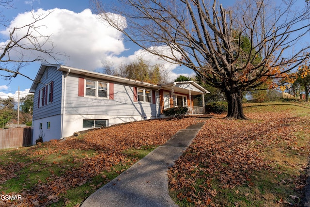 view of front facade featuring a porch and fence