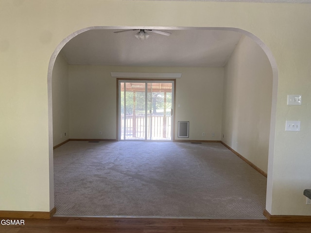 carpeted empty room featuring ceiling fan