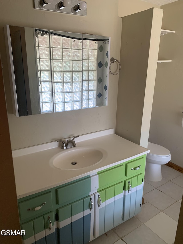 bathroom featuring toilet, vanity, and tile patterned floors