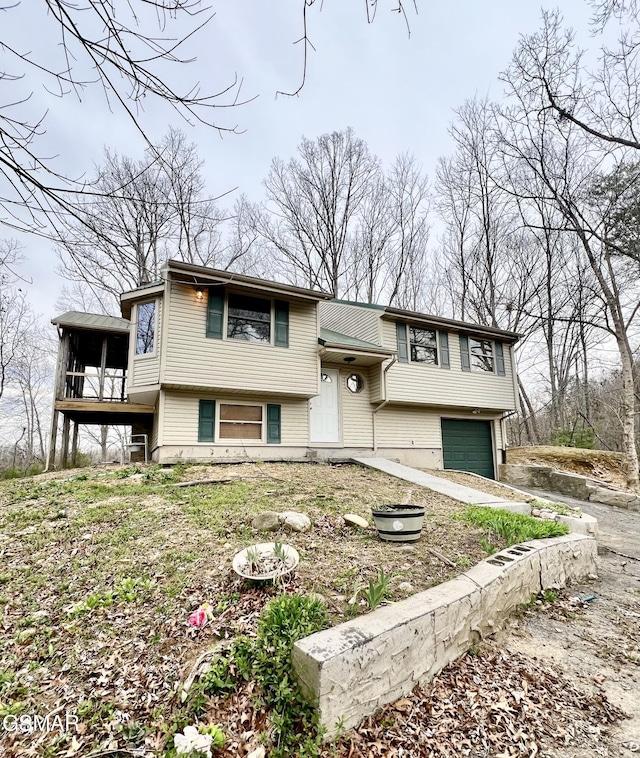 split foyer home featuring an attached garage and driveway