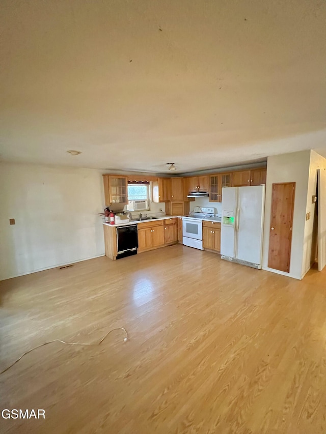 kitchen with white appliances, light wood-style floors, brown cabinetry, light countertops, and glass insert cabinets