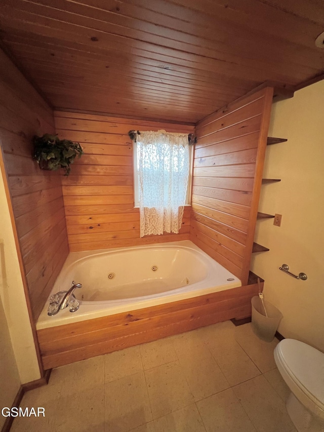 bathroom with a tub with jets, wood walls, wooden ceiling, and toilet