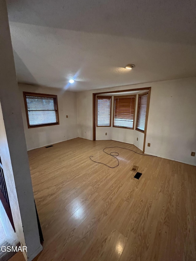 spare room with visible vents and wood finished floors