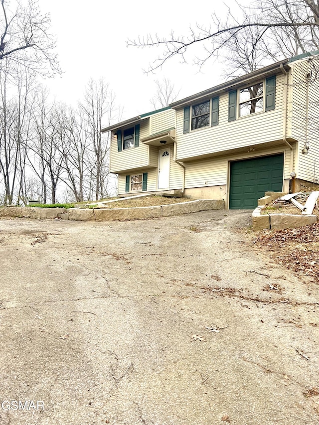 split foyer home with driveway and a garage