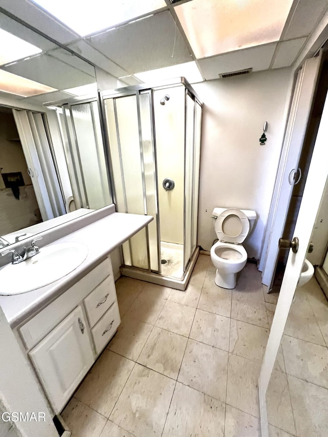 full bathroom featuring visible vents, a shower stall, toilet, vanity, and a paneled ceiling