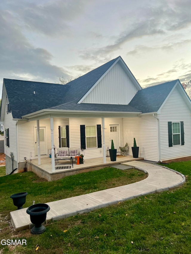 back of house featuring a patio, an outdoor hangout area, and a lawn