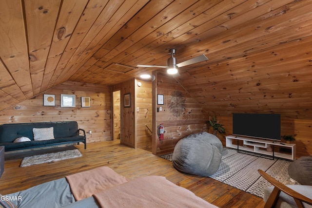 living room featuring wooden ceiling, hardwood / wood-style flooring, lofted ceiling, and wood walls