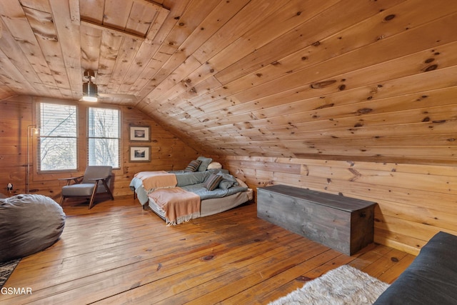 bedroom with wood ceiling, wood walls, vaulted ceiling, and hardwood / wood-style flooring