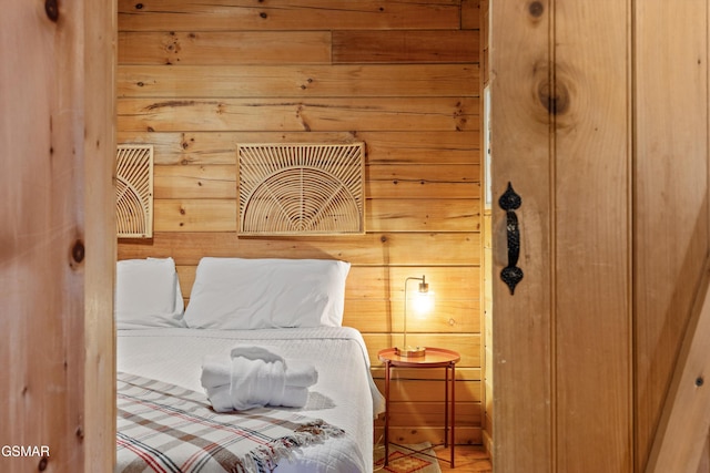 bedroom featuring wood walls