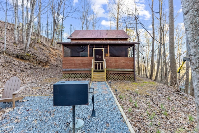 view of front of home with a sunroom and metal roof