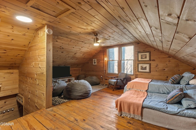 bedroom with lofted ceiling, wooden ceiling, wooden walls, and hardwood / wood-style flooring