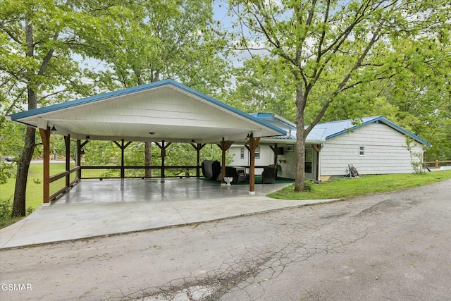 view of property's community featuring a carport and a lawn