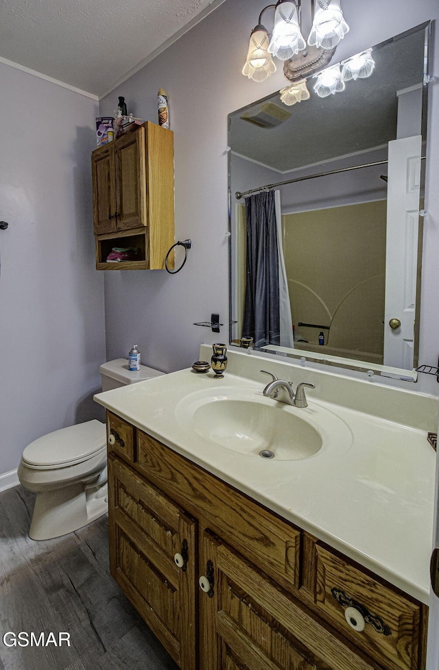 bathroom with walk in shower, a textured ceiling, vanity, hardwood / wood-style flooring, and toilet