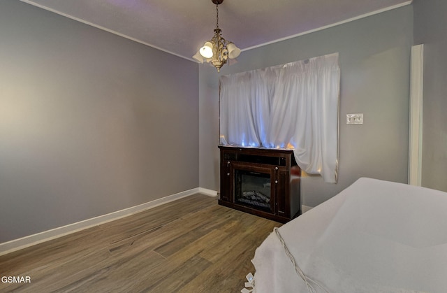 bedroom featuring dark wood-type flooring and a notable chandelier