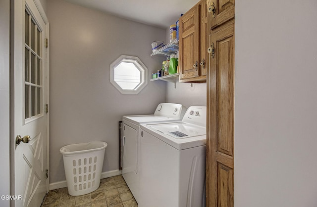 washroom featuring washer and dryer and cabinets