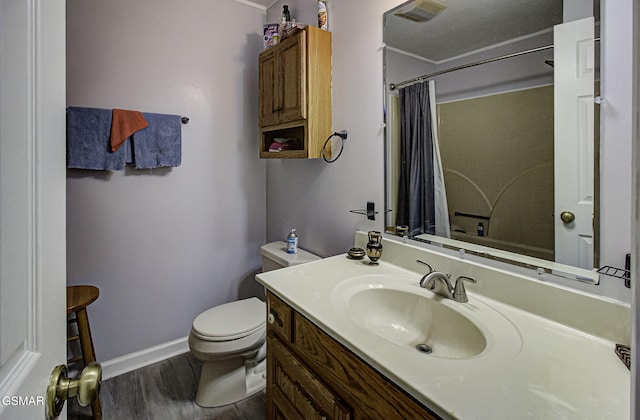 bathroom with vanity, crown molding, toilet, walk in shower, and wood-type flooring