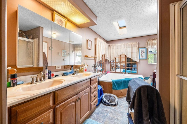 bathroom with vanity, independent shower and bath, a textured ceiling, and a wealth of natural light