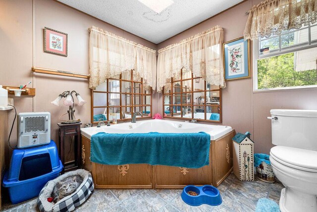 bathroom featuring toilet and a textured ceiling