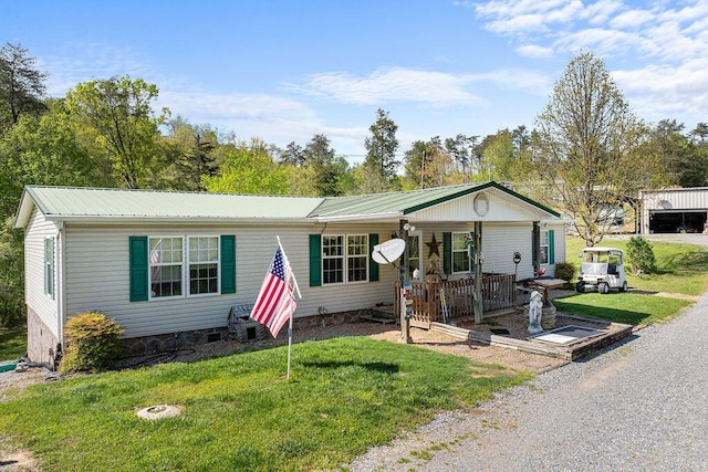 ranch-style home with covered porch and a front yard